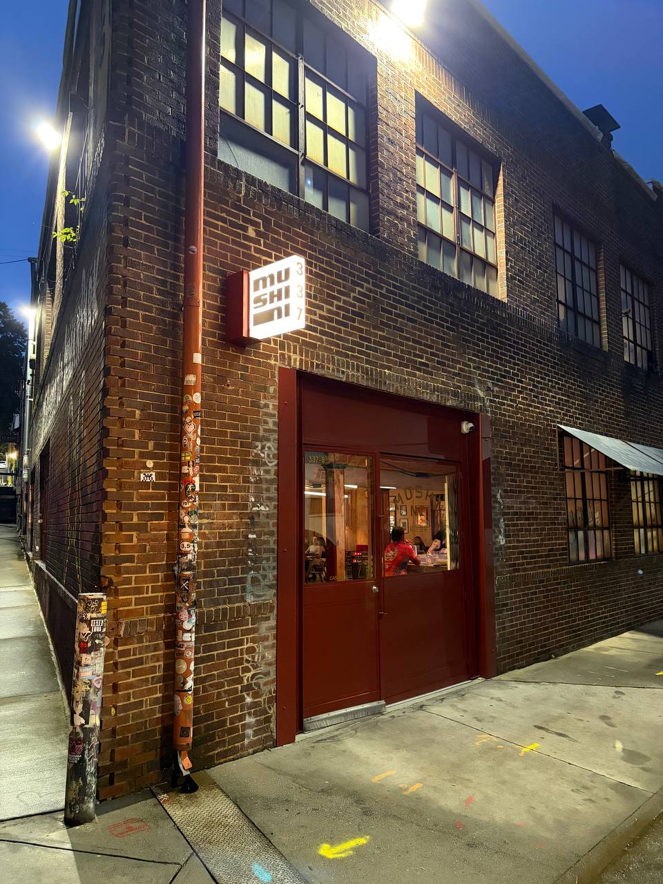 Mushi Ni's red-framed storefront entrance on Elizabeth Street NE
